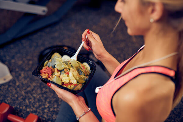Fit woman eating healthy foods