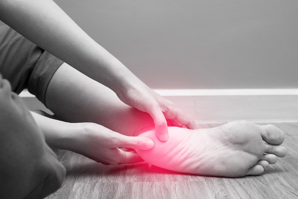image shows person with plantar facsiitis pain. Dr. Alex Rogers of New Life Wellness Center in Myrtle Beach, SC